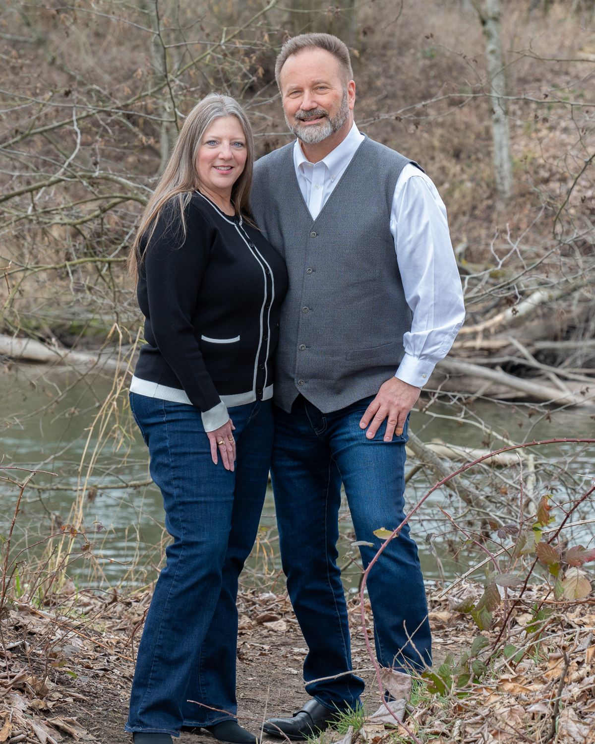 Jeff and Michelle Guykema of HeartLink Homes standing beside a river